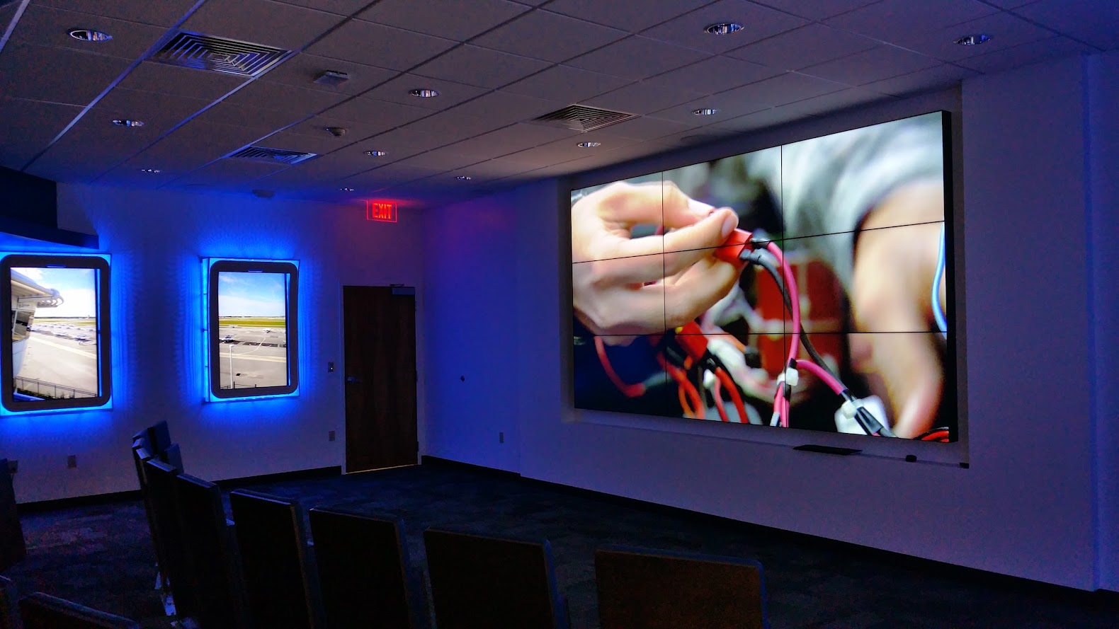 Large video wall in a room with blue accent lighting